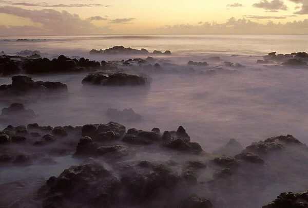 Hawaii, Molokai, Kau Poa Beach, Lava Rocks In Foggy Layer Over Pale Sunrise Water