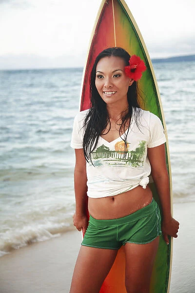 Hawaii, Oahu, Beautiful Local Girl Smiling And Holding A Colorful Surfboard At The Beach