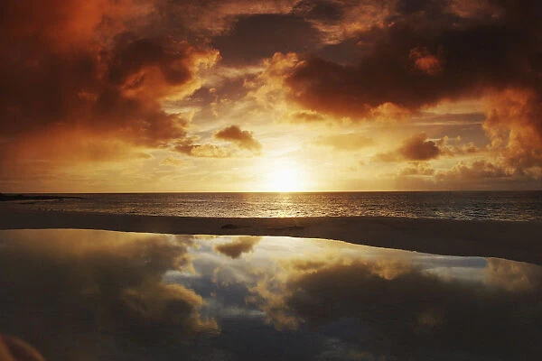 Hawaii, Oahu, North Shore, Beach Tidepool Next To Ocean Reflecting The Sunset Sky
