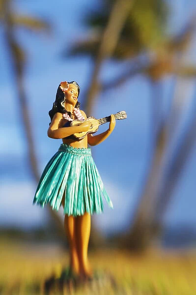 Hawaii, Oahu, Punaluu, Hula Doll On The Grass Beneath Palm Trees