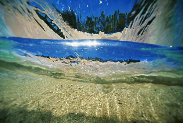 Hawaii, Underwater Breaking Wave, Sand, Sky And Trees Visible Through Clear Water