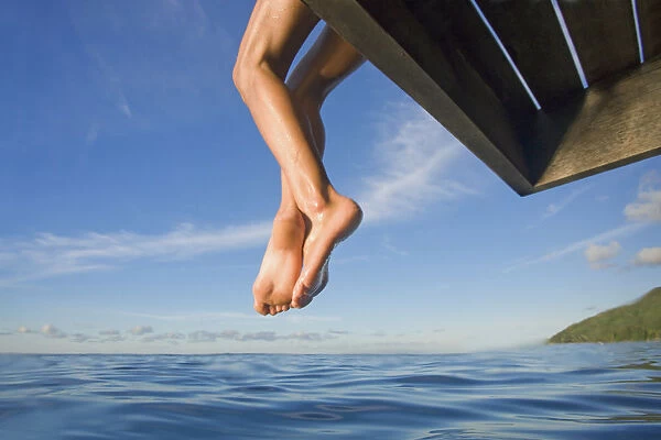 Hawaii, Womans Legs Hanging From Dock