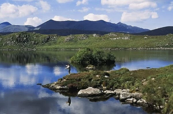 High Angle View Of A Man Fishing In The Lake, Barfinnihy Lake, Republic Of Ireland