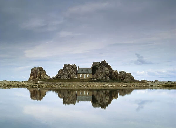 House In Between Rocks Reflected