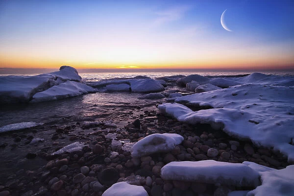 On The Icy Shores Of Lake Michigan The Moon (Double Exposed) And Ice Creates A Beautiful Morning; Wisconsin, United States Of America