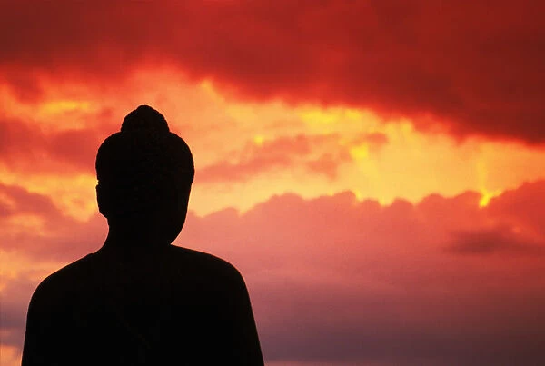 Indonesia, Java, Borobudur, Temple Relic, Buddhist Statue At Sunset, Silhouetted By Pink Sky