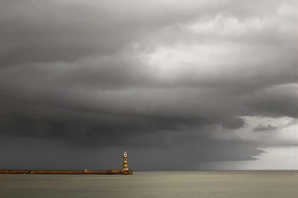 Lighthouse At The End Of A Pier With Dark Storm Clouds Overhead; Sunderland, Tyne And Wear, England