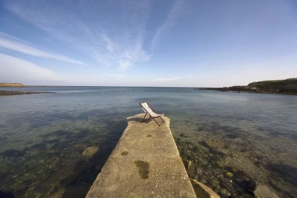 Lonely Deckchair At The Edge Of Pier; Northumberland, England, Uk