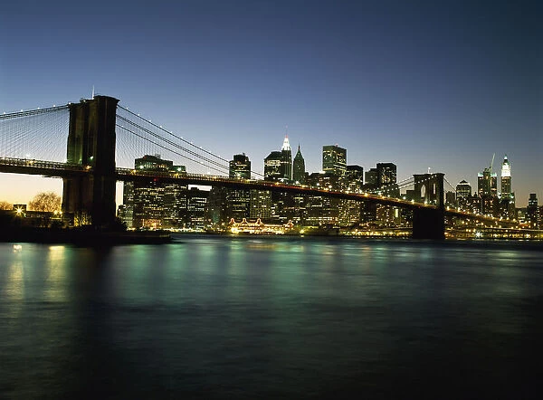 Looking Across The East River And The Brooklyn Bridge To The Financial District At Dusk