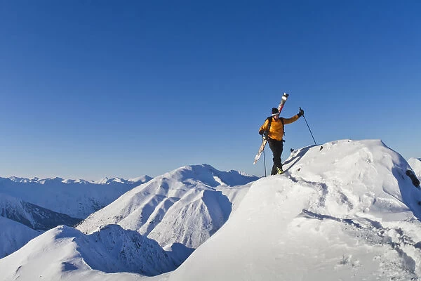 Man Climbing A Snow Ridge For Back Country Skiing, Turnagain Pass, Kenai Mountains, Southcentral Alaska, Winter