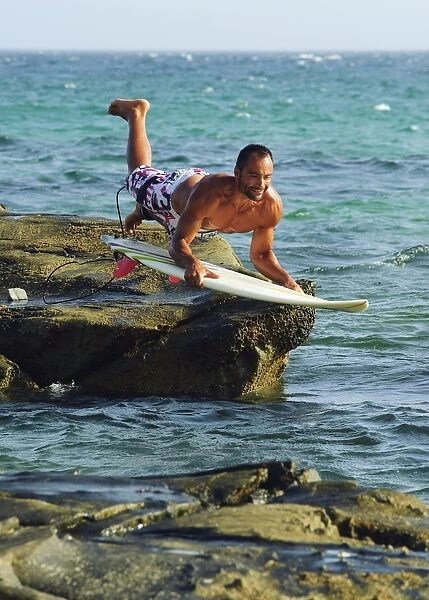 Man Jumping Into The Water On His Surf Board