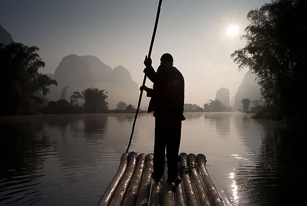 Man On Raft In Mountain Area; Yulong River, Yangshuo, China