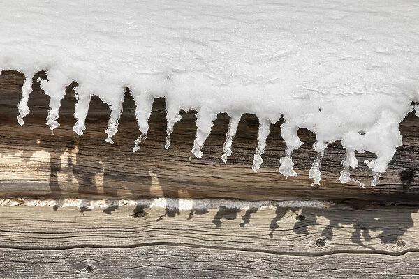 Detail of melting snow hanging from roof, Nulato, Alaska, USA
