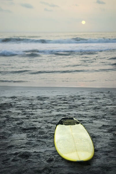 Mexico; Surfboard Lying On Sand