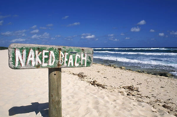 Mexico, Yucatan Peninsula, Cozumel, Naked Beach Sign In Sand, Ocean And Blue Sky In Background