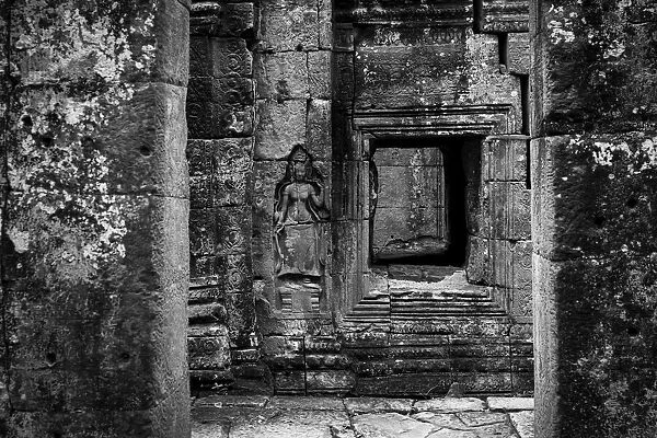 Monochrome bas-relief of crowned woman beside window, Banteay Kdei, Angkor Wat, Cambodia