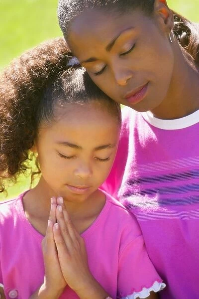 Mother And Daughter Praying