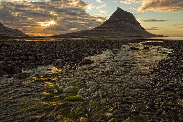 The Mountain Kirkjufell Rises Above The Ocean As The Sun Sets On The Snaefellsnes Peninsula; Iceland