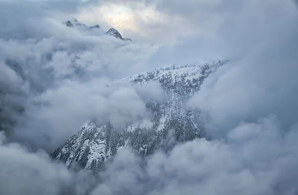 The Mountains Of Golden Ears Provincial Park Are Shrouded In Clouds In The Aerial Photo; British Columbia, Canada