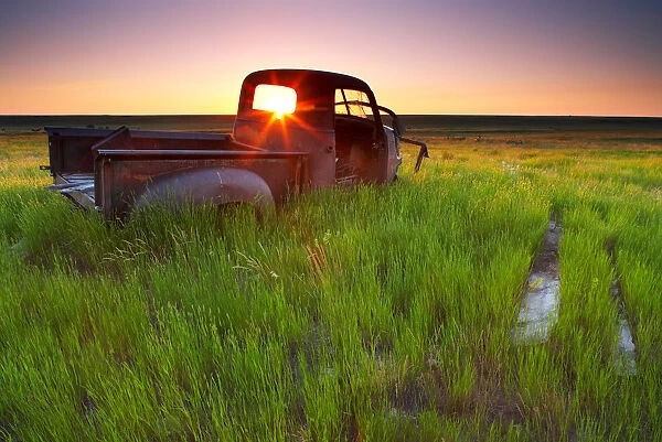 Old Abandoned Pick-Up Truck Sitting In A Field At Sunset, Southwestern Saskatchewan
