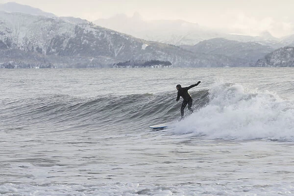 Person Surfing In Winter In Homer, Kenai Peninsula, Kachemak Bay, Alaska