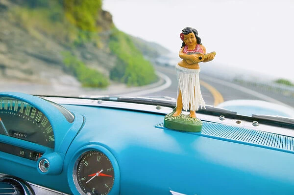Plastic Hula Doll On The Dashboard Of A Turquoise Thunderbird