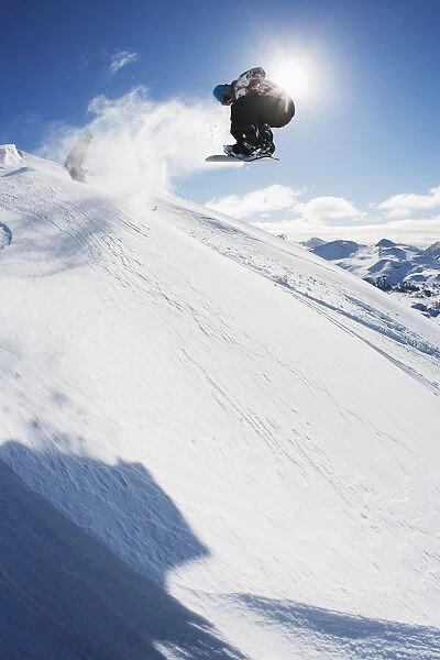 Professional Snowboarder Making A Jump In Fresh Snow Near Ushuaia, Patagonia, Argentina