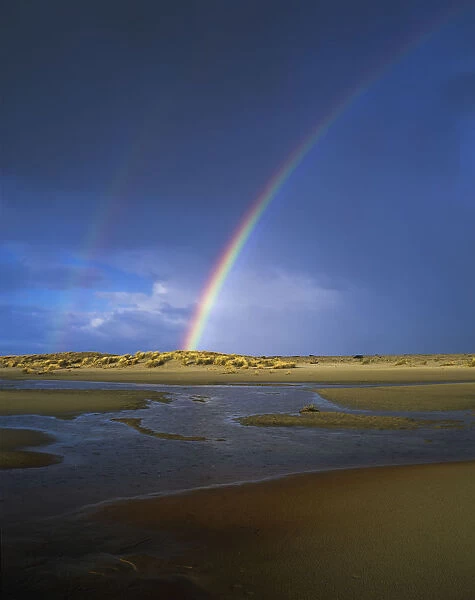 Rainbow Appears Over The Mouth Of The Siltcoos River; Florence, Oregon, United States Of America