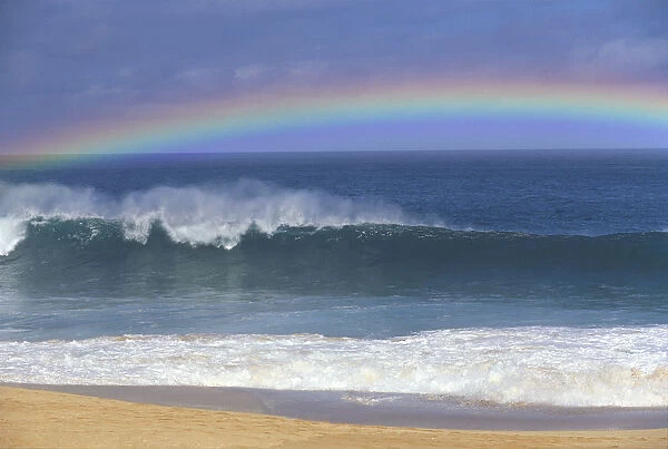Rainbow Over Shore Break Beach Foreground, Horizon And Blue Sky With Clouds A21E