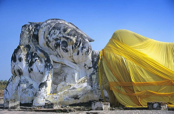 Reclining Budda statue wrapped with yellow cloth