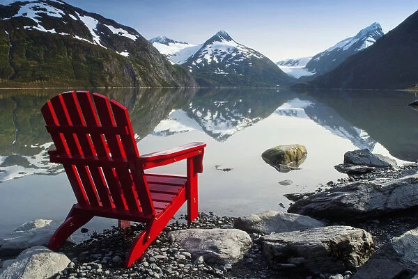 Red Adirondack Chair At Portage Lake With Chugach Mountains In The Background, Southcentral, Alaska
