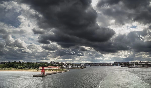 Red Herd Groyne Lighthouse At The End Of A Pier Under Storm Clouds; South Shields, Tyne And Wear, England