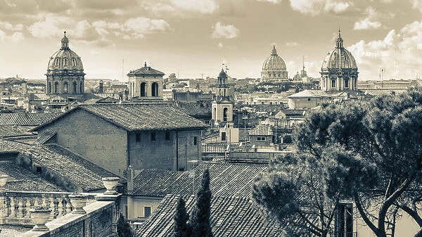 Rome, Italy. Rooftops and domes. In the far distance is St. Peter s. The historic centre of Rome is a UNESCO World Heritage Site