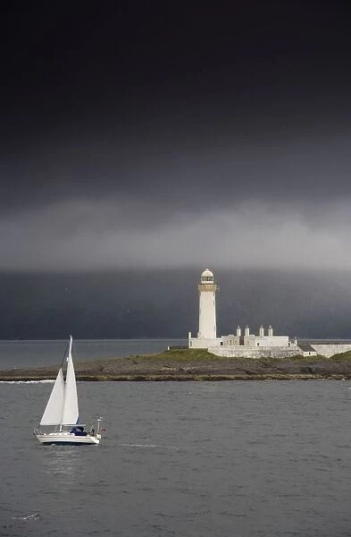 Sailboat Near A Shore With A Lighthouse; Eilean Musdile In The Firth Of Lorn, Scotland