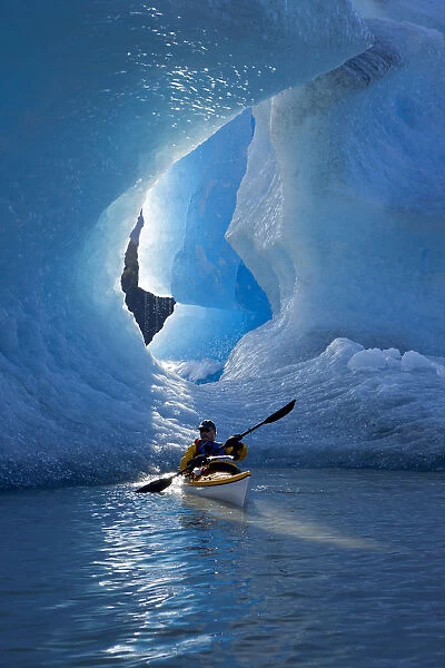 Sea Kayaker On Mendenhall Lake With Big Blue Iceberg In The Background, Southeast Alaska, Summer