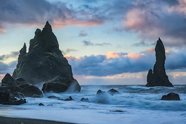 The Sea Stacks Known As Reynisdrangar With Waves And Sunrise Happening Above Them, South Coast; Iceland