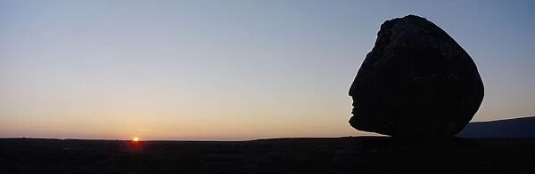 Silhouette Of Head-Shaped Boulder At Dusk