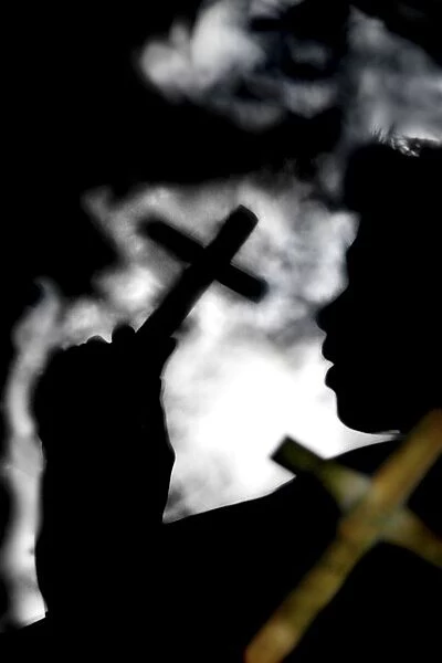 Silhouette Of Person Holding Cross