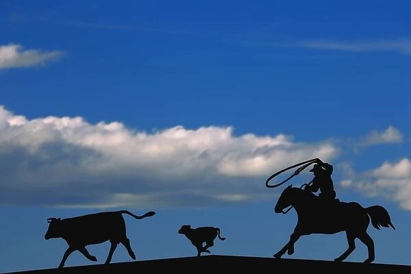 Silhouette Of A Rancher Roping Cattle