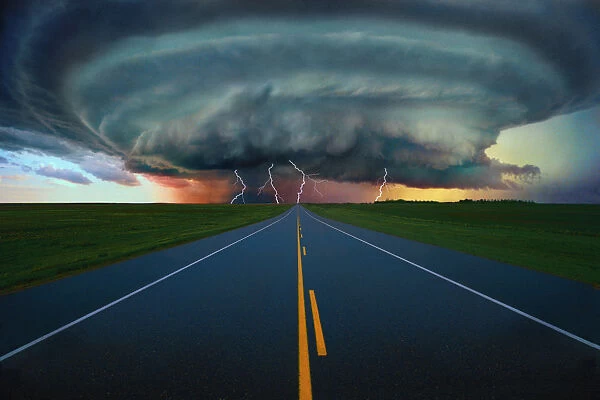 Single Lane Road Leading To Storm Cloud