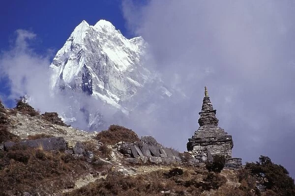 Snow Covered Peak With Cultural Monument In Forefront