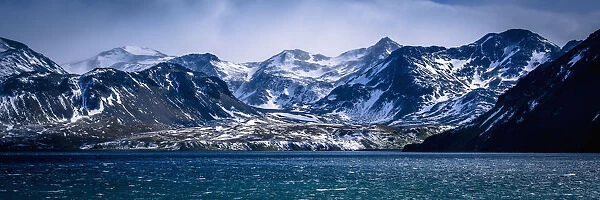 Snowy Mountains In Sunshine Beside Blue Sea; Antarctica