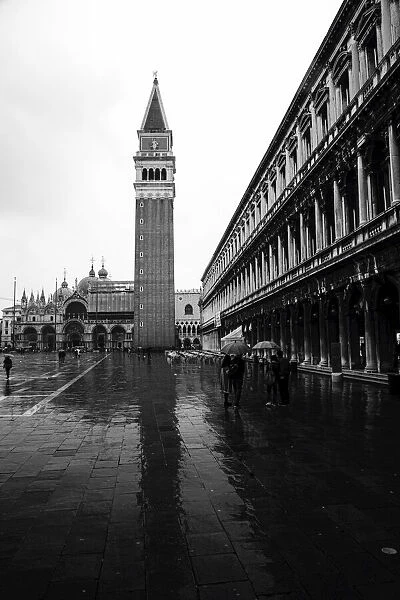 St Marks Campanile and St Marks Basilica in St Marks Square on a rainy day, Venice, Italy