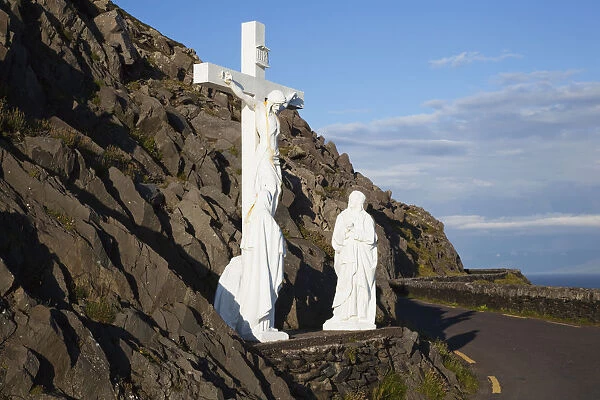 Statue of jesus christ on the cross with two women at the foot of the cross on the side of the road; County kerry, ireland