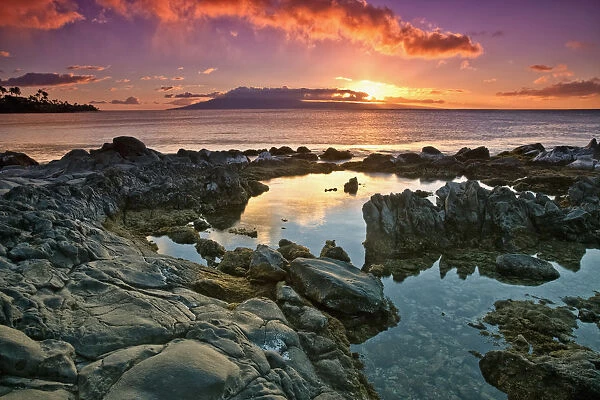Sunset Reflected In The Tranquil Tide Pools Along The Coast; Hawaii, United States Of America