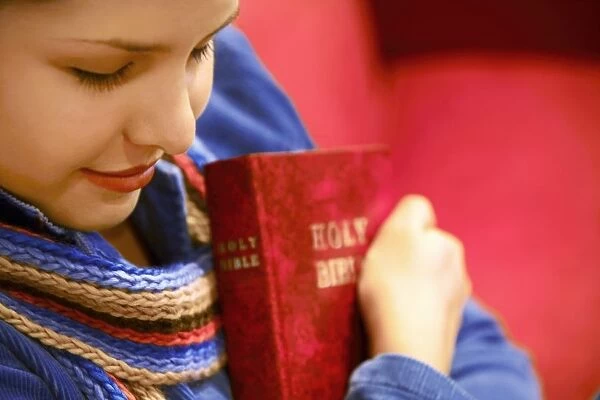 Teen Holds Bible And Prays