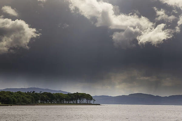 Trees And Mountains Along The Coastline Under Storm Clouds; Otter Ferry, Scotland