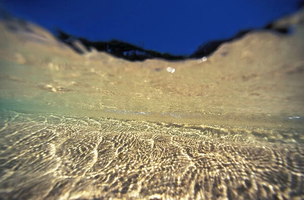 Underwater Reflections Along Sandy Bottom, At Surface Blue Sky Visible
