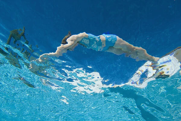 Underwater View Of Woman Diving Into Pool