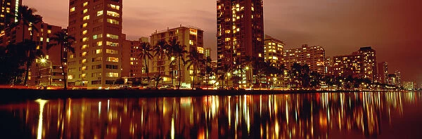 USA, Hawaii, Kauai, Glow Of City Lights On Ala Wai Canal At Dusk; Waikiki